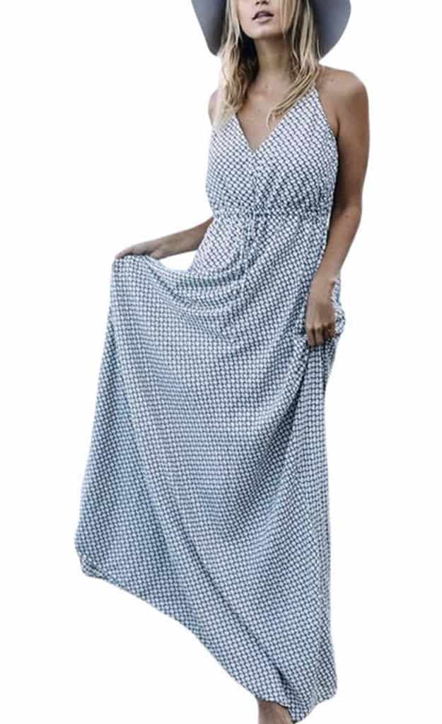 A model wearing a floor-length spaghetti strap maxi dress a grey and blue diamond pattern.