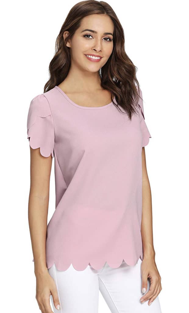 A model wearing a light lilac purple blouse with scalloped sleeves.
