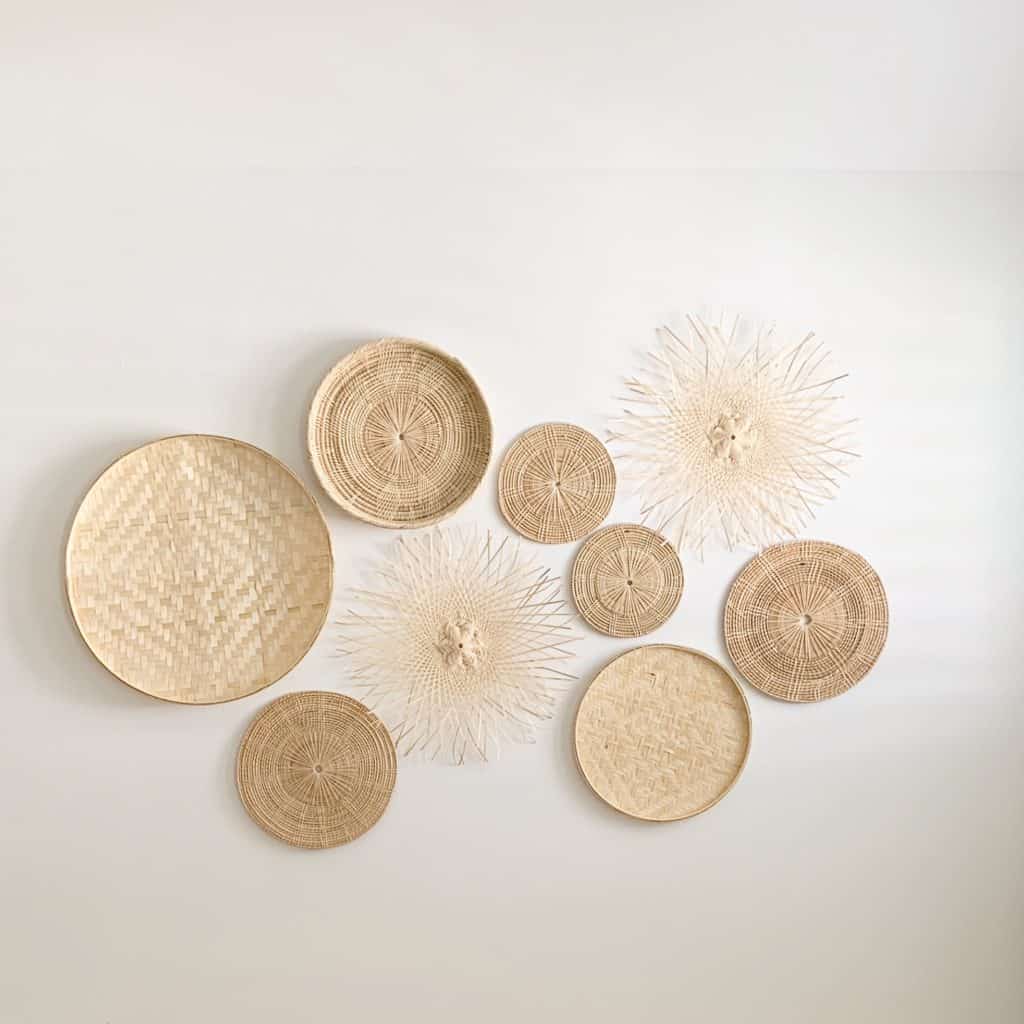 The kids shared bedroom is decorated with an Olive and Iris basket wall made up of various woven wood baskets.