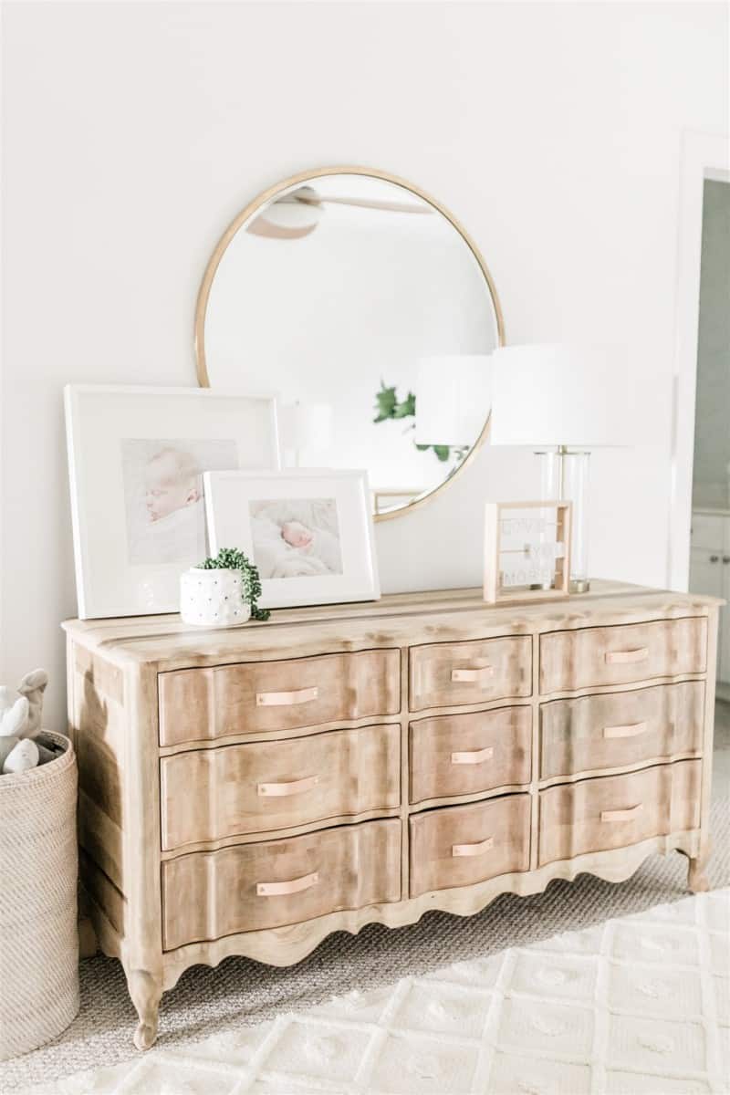 How to refinish a dresser: this gorgeous tan wood dresser lives in our son's nursery, decorated with baby pictures and modern nursery decor.