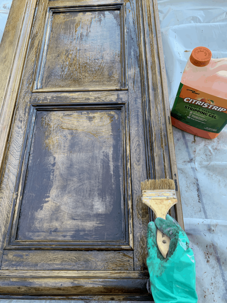 In order to properly remove the wood stain and refinish this wooden headboard, I reapply the Citristrip stripping gel for a second coat.