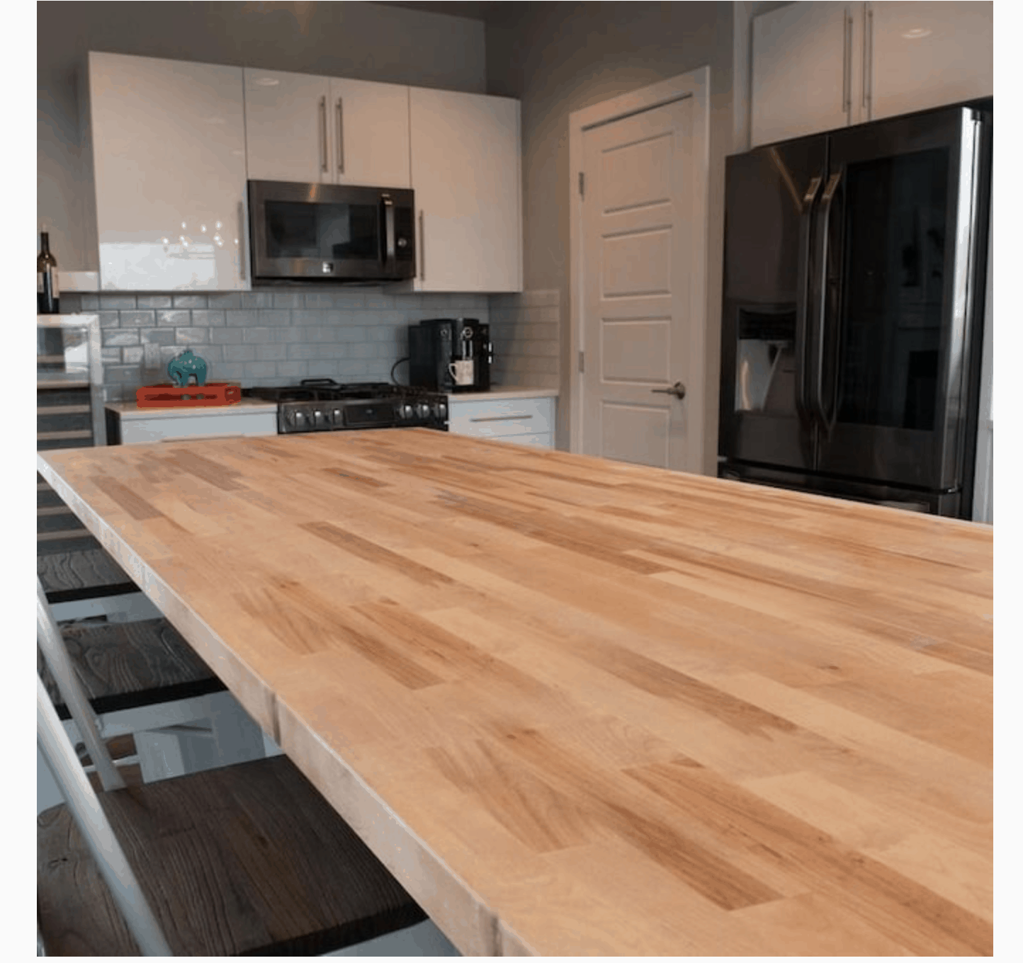 A butcher block countertop in the laundry room would add space and functionality to our upgraded laundry room. #butcherblock #paintedfloors #paintedtilefloors #coastalhome #coastaldecor #coastallaundryroom #laundryroomfloors #slatetile #verticalshiplap #vintagedecor #vintagerug #laundryroomrug