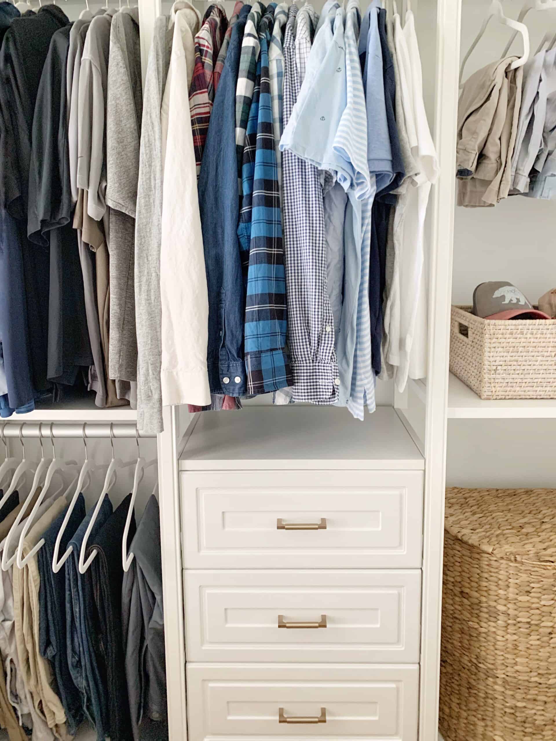 Another look at my husband's side of the master closet - shirts, pants, and baseball caps all organized with hangers and baskets.