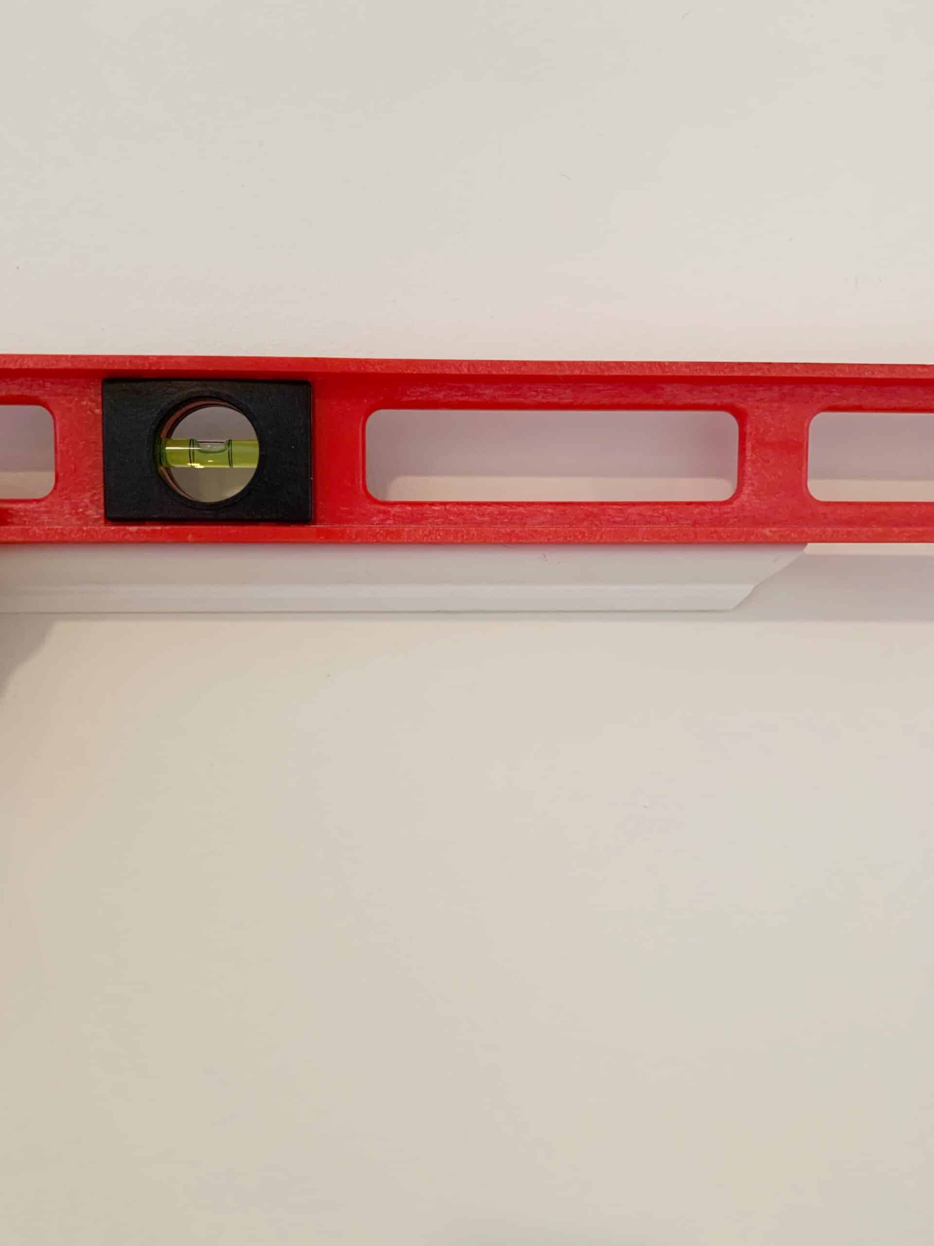 How to install picture frame molding, the easy way, using miter shears and PVC molding. No saw required. #millwork #molding #moulding #pictureframemolding #pictureframemoulding #pvctrim #pvcmillwork #walltrim #walltreatment