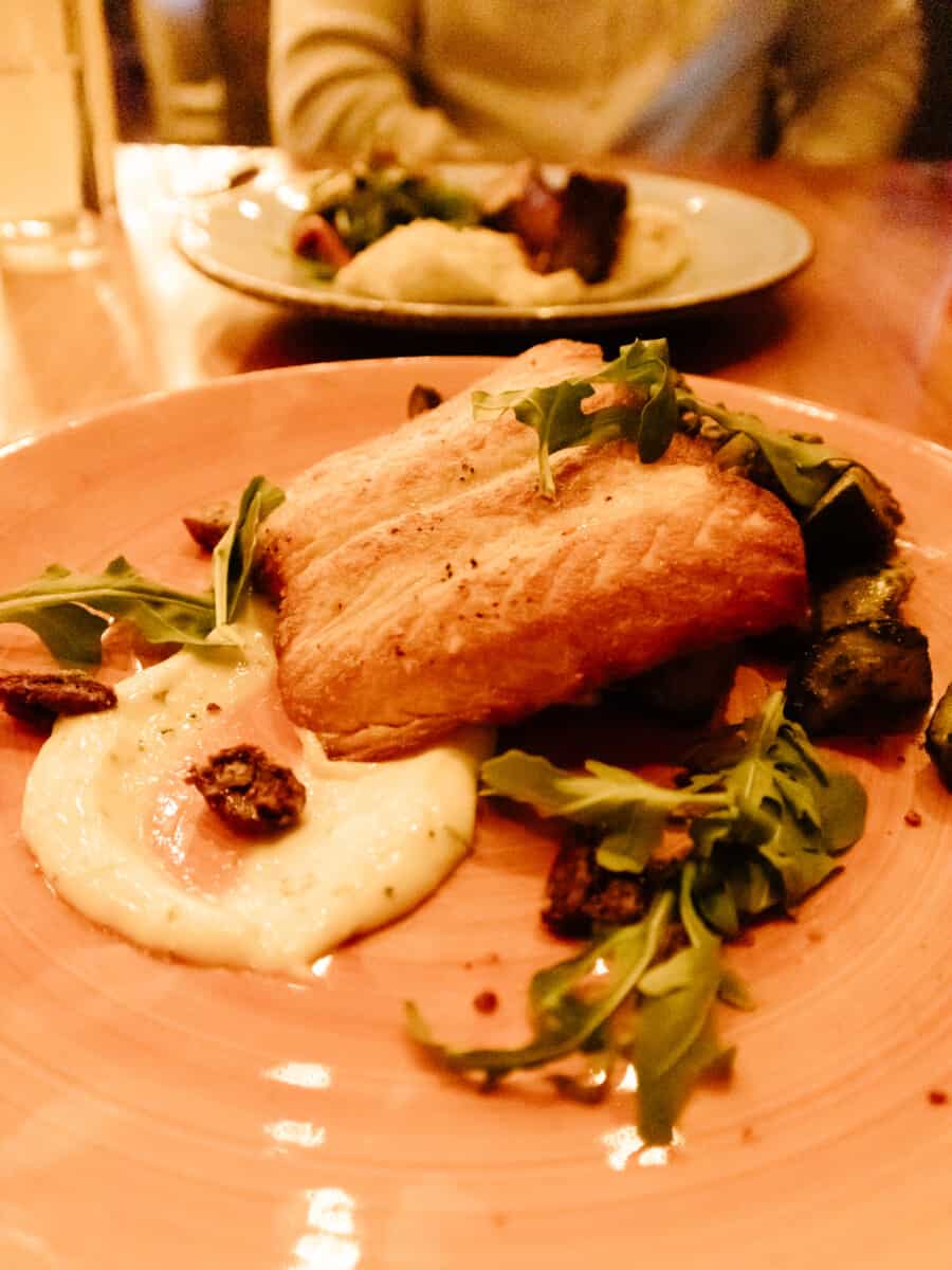 Our dinner entrees - fish with greens and grits at Edison Craft Ales and Kitchen restaurant in Asheville NC. #groveparkinn #nationalgingerbreadcompetition #gingerbread #giantgingerbreakhouse #asheville #northcarolina #visitasheville #ashevillehotels #ashevilleresort #mountainvacation