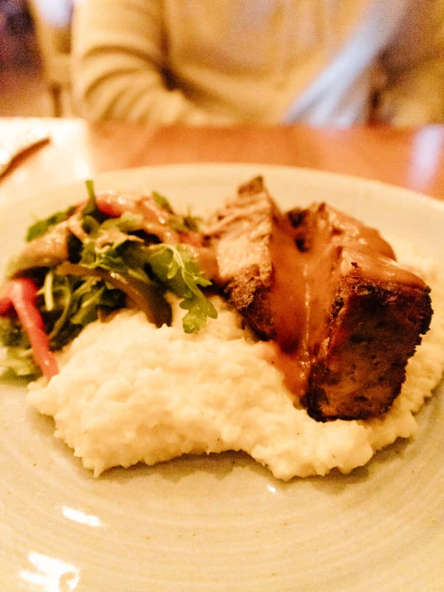 Dinner entrees at Edison Craft Ales and Kitchen in Asheville NC - meatloaf and gravy with greens and mashed potatoes. #groveparkinn #nationalgingerbreadcompetition #gingerbread #giantgingerbreakhouse #asheville #northcarolina #visitasheville #ashevillehotels #ashevilleresort #mountainvacation