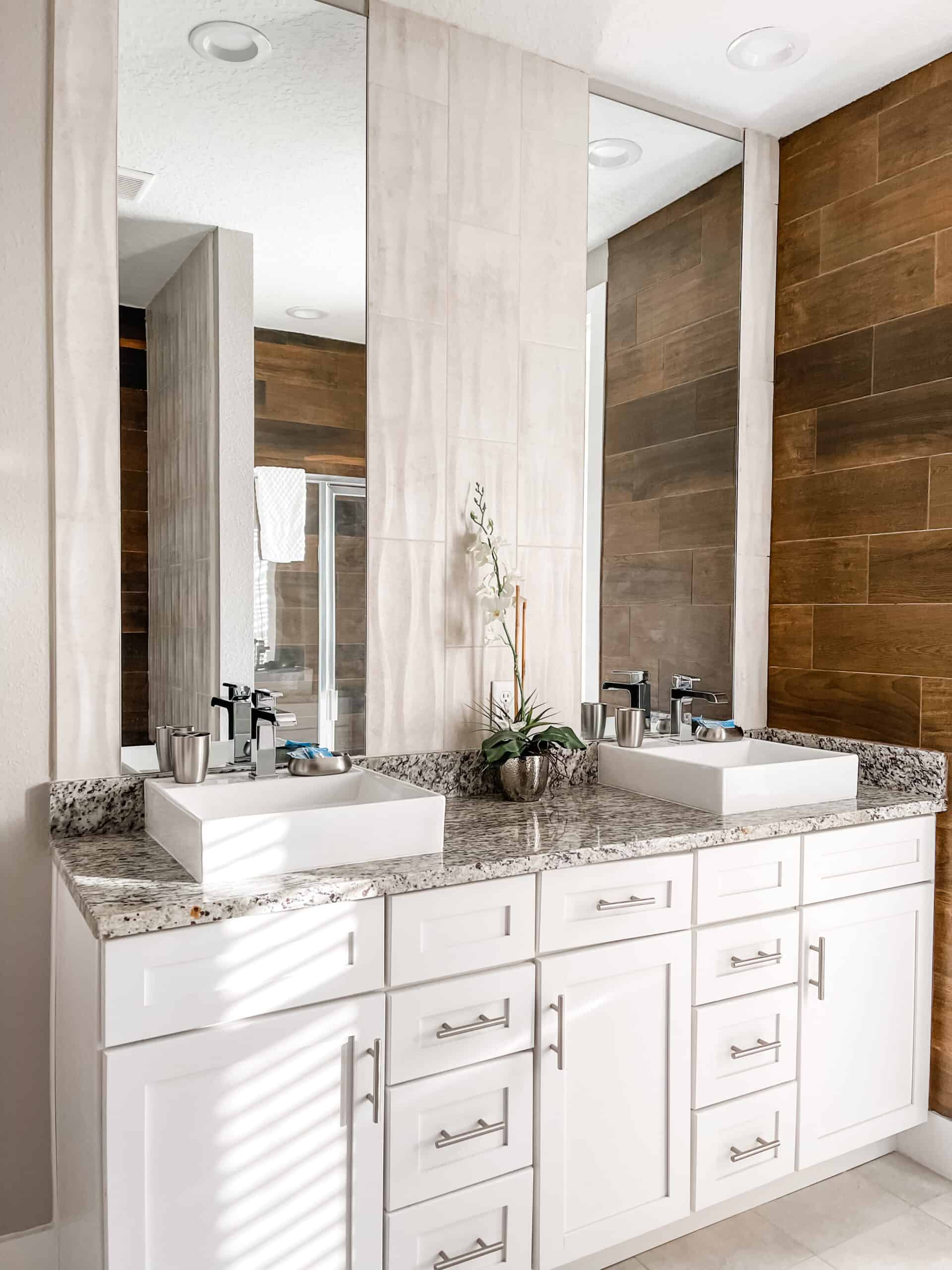 A gorgeous bathroom with dual sinks and mirrors and granite countertops. This bathroom was in our Airbnb in Orlando FL #disneyworld #disney #kissimmee #orlando #florida #offproperty #disneyresort