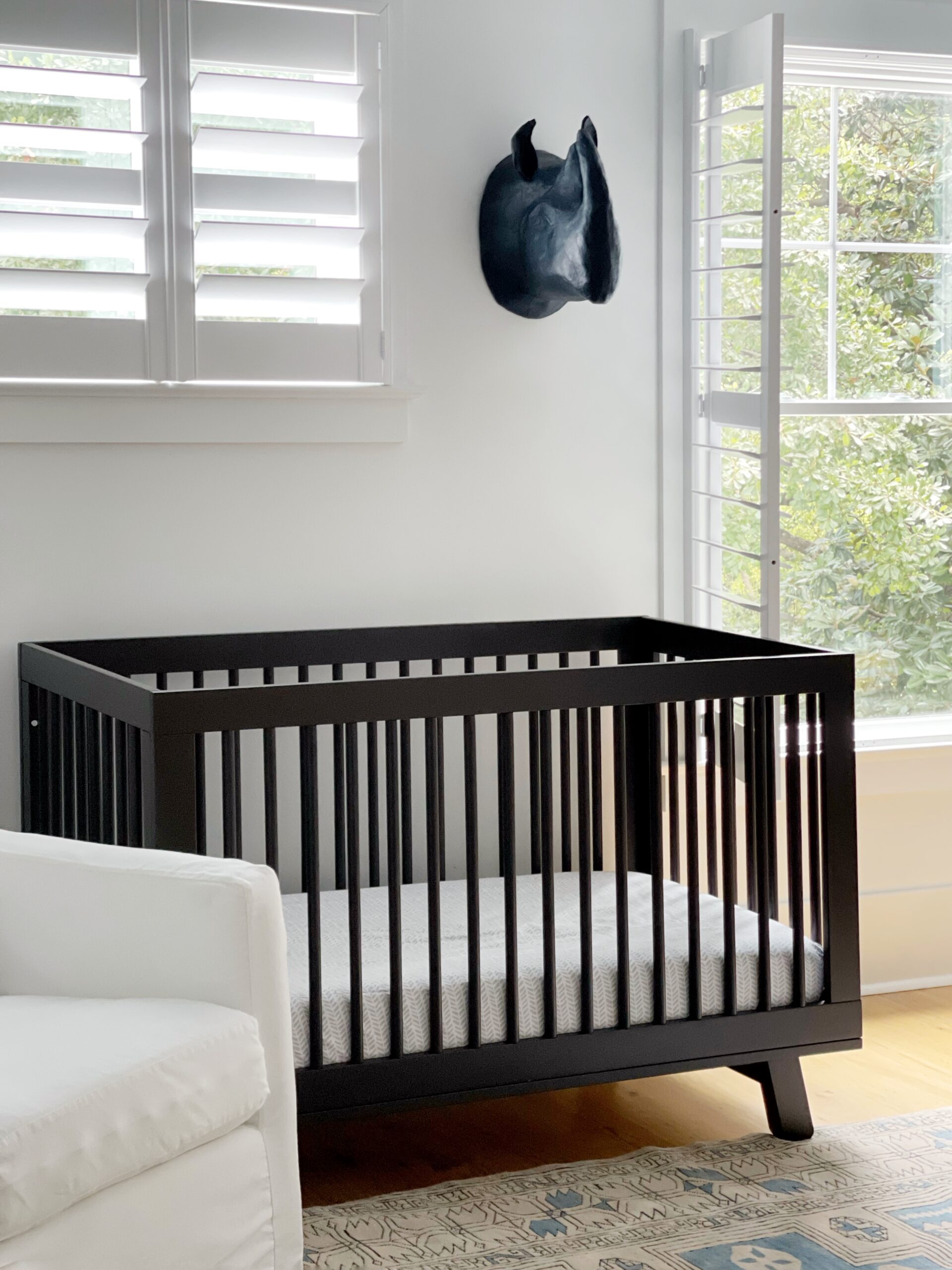 Black crib that's modern for a boy's nursery.