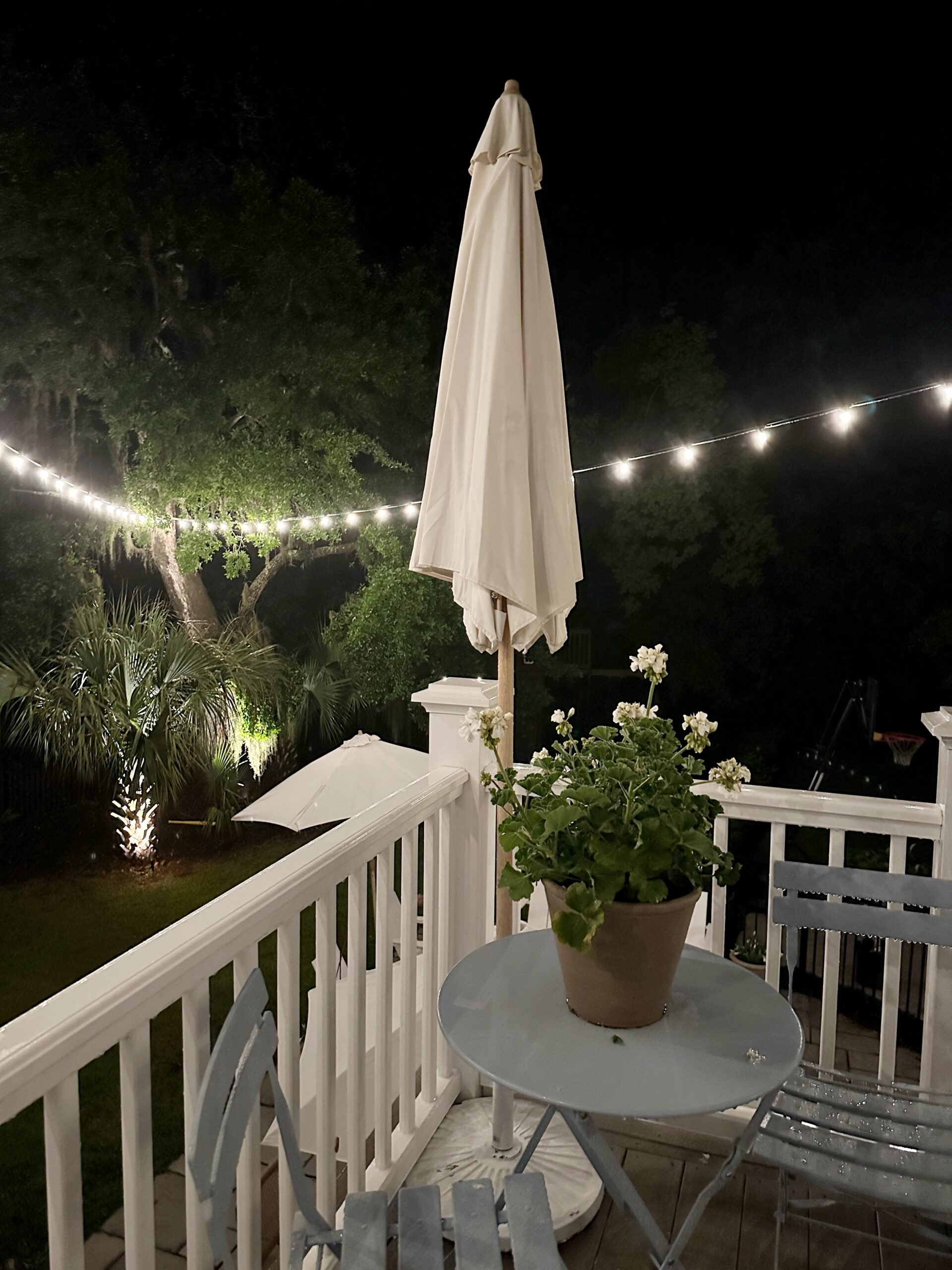 Deck bistro lighting attached to the oak tree.