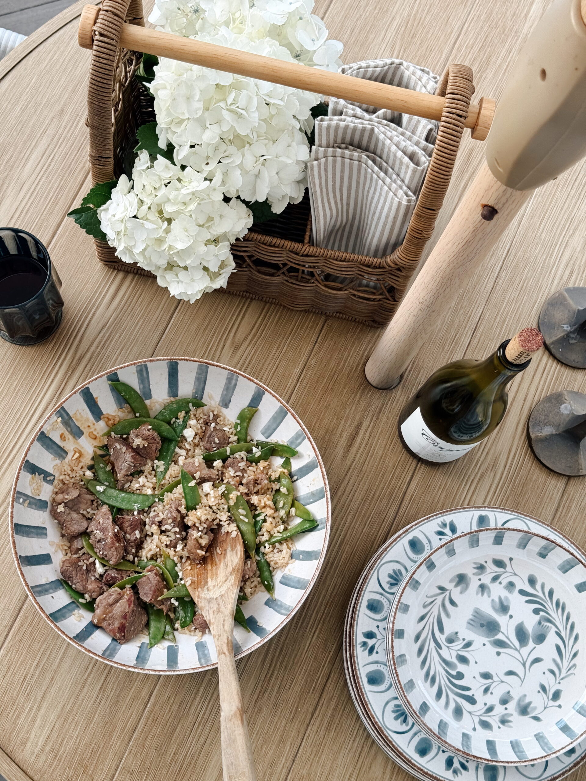 Trader joes beef and rice dinner with snap peas on blue walmart dishes.