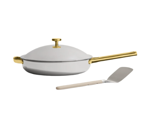 Our Place Titanium Pro Pan in large size, featuring a high-performance cooking surface and elegant gold-accented handles for elevated stovetop style.