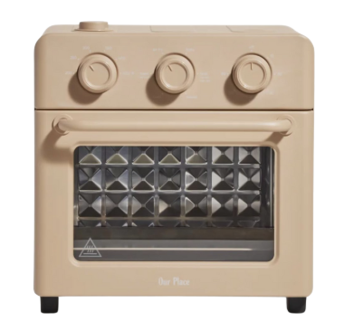 Our Place Wonder Oven in Steam color, a compact countertop appliance with a sleek neutral finish, ideal for air frying, baking, toasting, and roasting.
